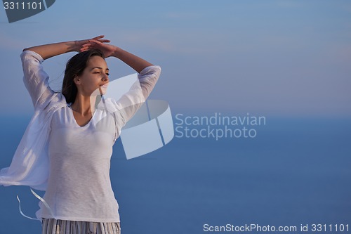 Image of young woman enjoy sunset