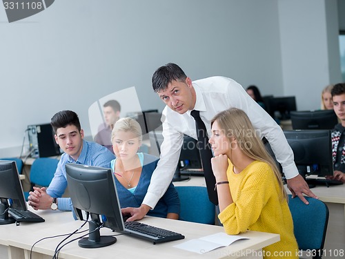 Image of students with teacher  in computer lab classrom
