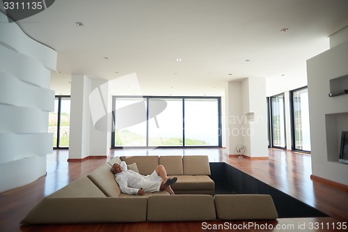 Image of Portrait of senior man relaxing in sofa