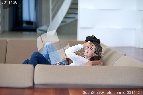 Image of couple at modern home using tablet computer