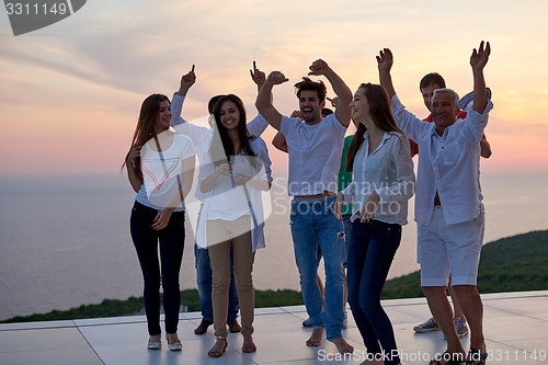 Image of party people  on sunset