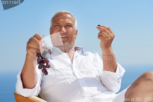 Image of senior man sitting outside