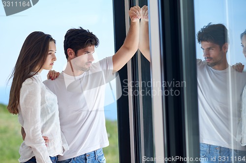 Image of relaxed young couple at home staircase