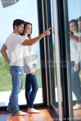 Image of relaxed young couple at home staircase