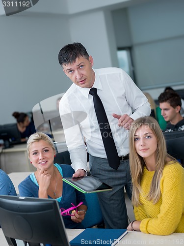 Image of students with teacher  in computer lab classrom