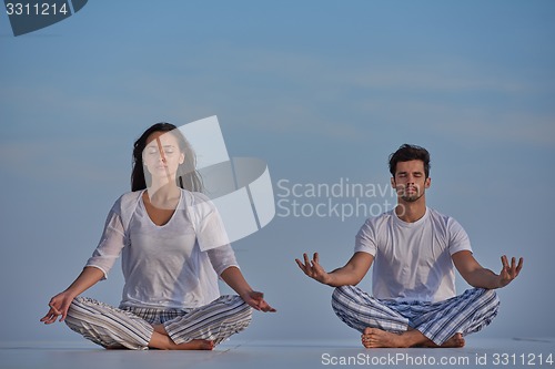 Image of young couple practicing yoga