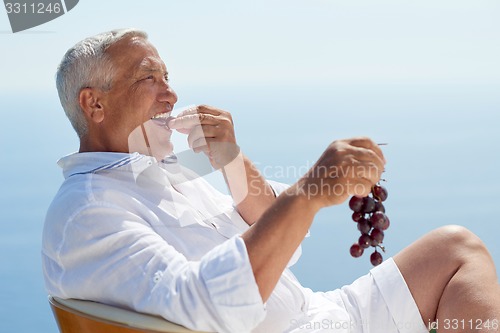 Image of senior man sitting outside