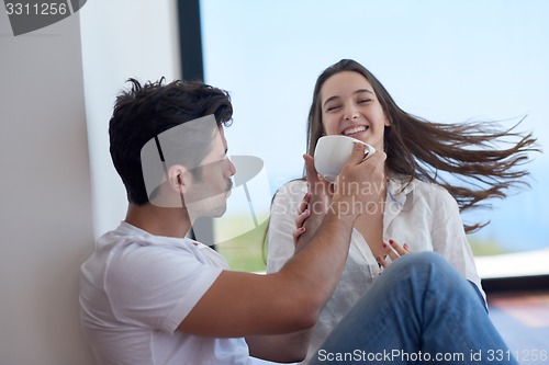 Image of relaxed young couple at home staircase