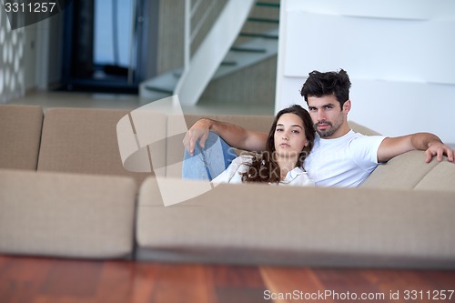 Image of relaxed young couple at home staircase