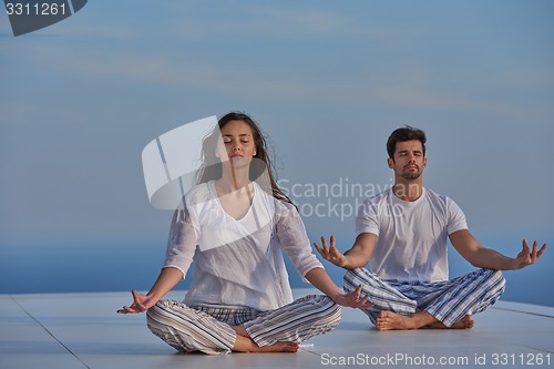 Image of young couple practicing yoga