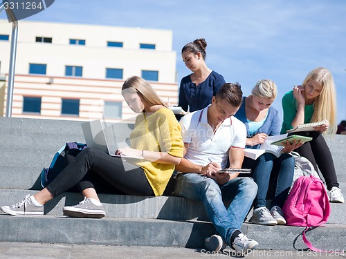 Image of students outside sitting on steps