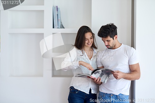 Image of relaxed young couple at home staircase