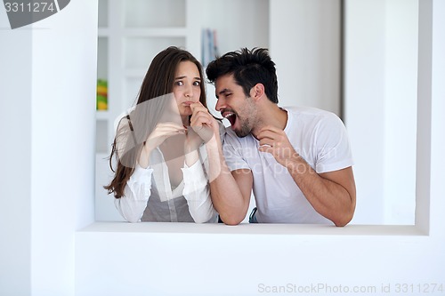 Image of relaxed young couple at home staircase