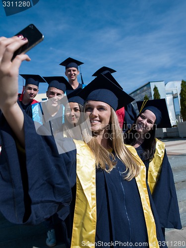 Image of students group in graduates making selfie