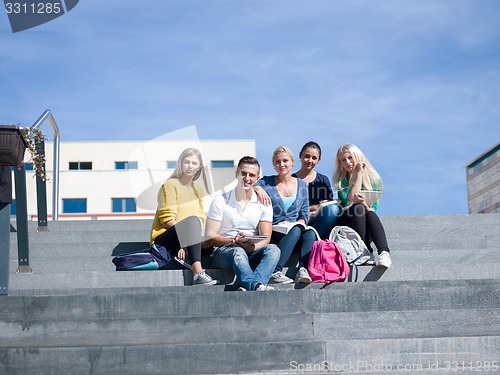 Image of students outside sitting on steps