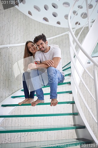 Image of relaxed yung couple at home  stairs