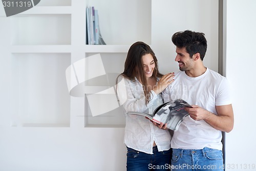 Image of relaxed young couple at home staircase