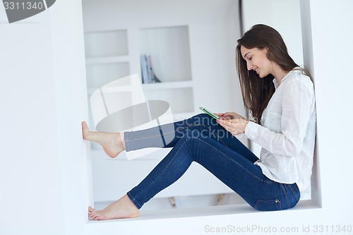 Image of woman at home using tablet