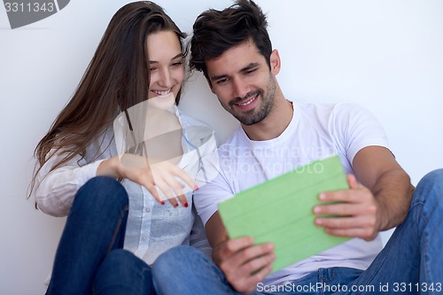 Image of couple at modern home using tablet computer