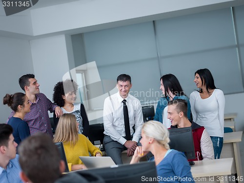 Image of students with teacher  in computer lab classrom