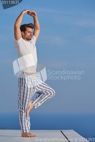 Image of young man practicing yoga