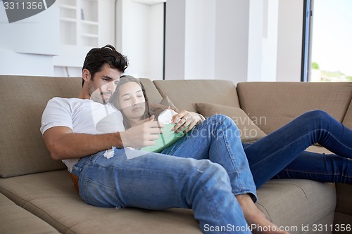 Image of couple at modern home using tablet computer