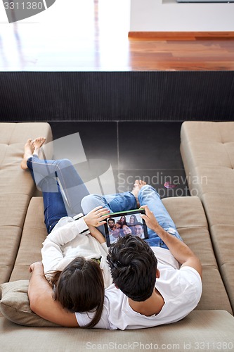 Image of couple at modern home using tablet computer