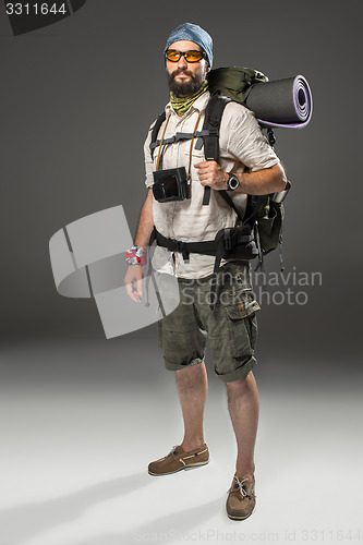 Image of Full length portrait of a male fully equipped tourist 