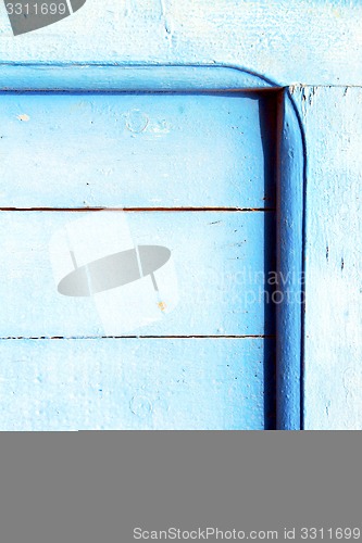 Image of nail stripped   in the blue wood door  rusty 