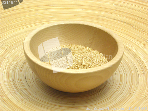 Image of Wooden bowl with amaranth on bamboo plate