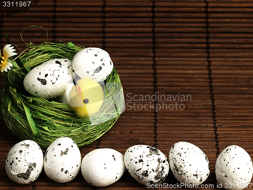 Image of Easter chicken and eggs in the nest.