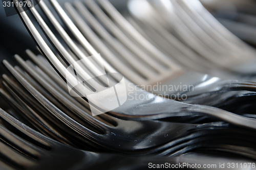 Image of Forks arranged in series on the kitchen table.