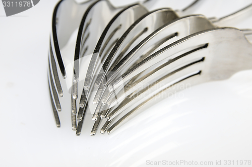 Image of Forks arranged in series on the kitchen table.