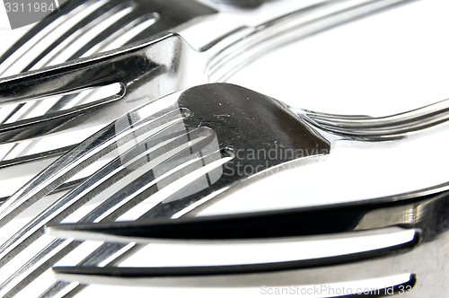 Image of Forks arranged in series on the kitchen table.