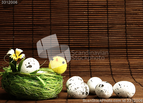 Image of Easter chicken and eggs in the nest.