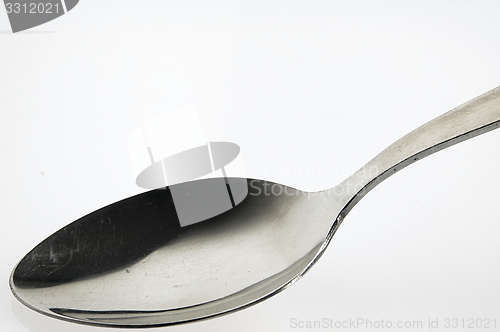 Image of Spoon on the white table.