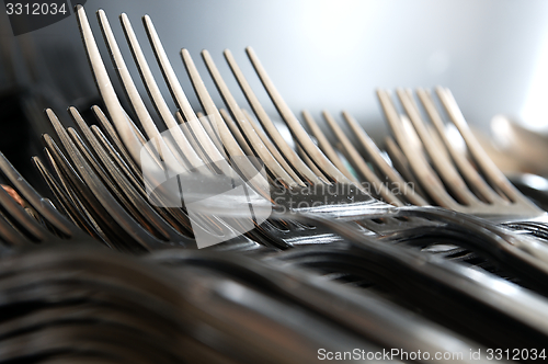 Image of Forks arranged in series on the kitchen table.