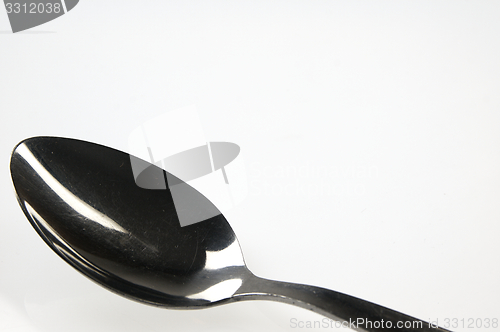 Image of Spoon on the white table.