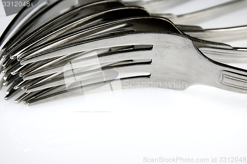 Image of Forks arranged in series on the kitchen table.