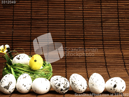 Image of Easter chicken and eggs in the nest.