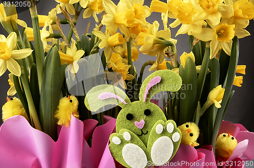 Image of Easter bunny and yellow daffodils.