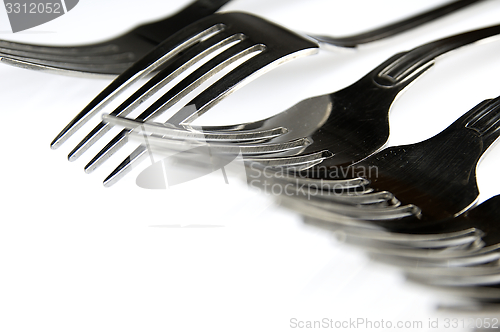 Image of Forks arranged in series on the kitchen table.