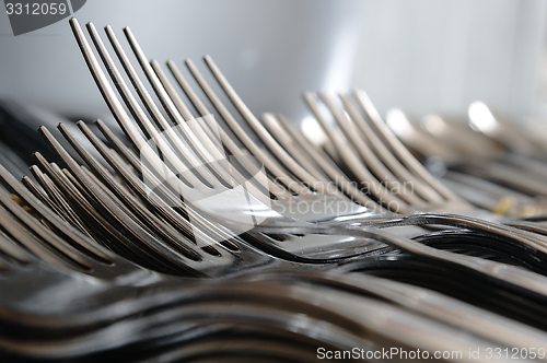 Image of Forks arranged in series on the kitchen table.