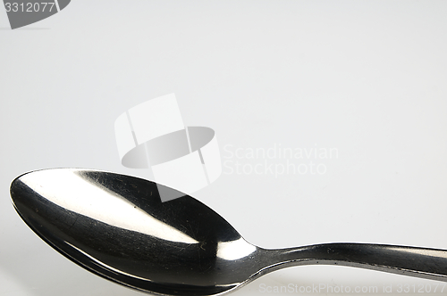 Image of Spoon on the white table.