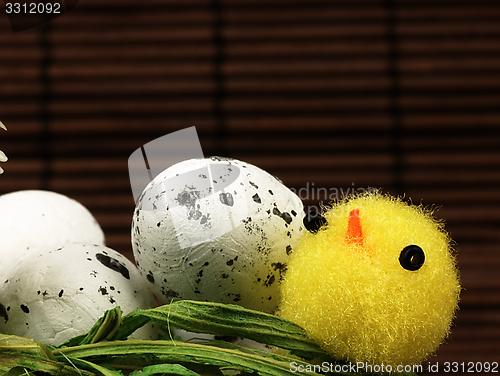 Image of Easter chicken and eggs in the nest.