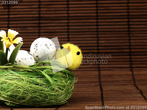 Image of Easter chicken and eggs in the nest.