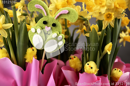 Image of Easter bunny and yellow daffodils.