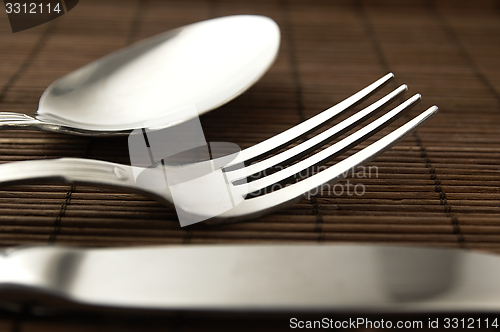 Image of Cutlery on a wooden background.