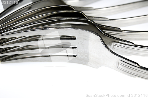 Image of Forks arranged in series on the kitchen table.