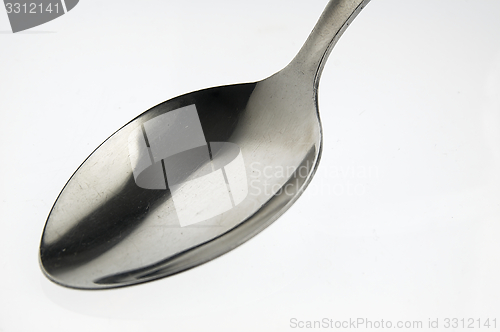 Image of Spoon on the white table.